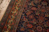 Geometric finned floral border in saffron and red on an antique cobalt blue Bijar rug runner.