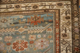 Distressed Malayer runner corner with dusty teal field, serrated terracotta designs, and beige borders.
