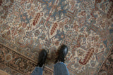 Distressed vintage Heriz carpet: ivory, denim, rust botanical field, distinct Turtle Samovar border.