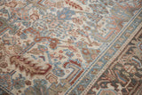 Distressed Heriz rug: worn ivory field, denim blue palmettes, Turtle Samovar border section.