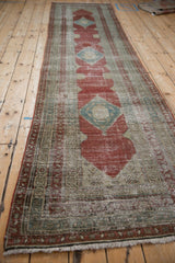 Antique Serbend runner viewed from an angle, showcasing its long form and distressed diamond pattern.