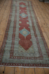 Angled view of a distressed Serbend runner highlighting its full length and diamond medallion pattern.
