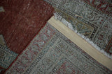 Corner detail of an antique Serbend rug showing the back weave, secured edge, and worn red pile.