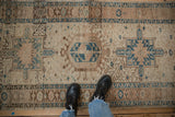 Distressed Persian Karaja runner segment, featuring heavy abrashes, geometric motifs, and dusty blue hues.