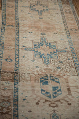Close-up of distressed vintage Karaja runner, showing geometric patterns, abrash, and palmette border.