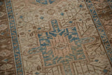 Distressed Karaja runner's dusty blue geometric hook and latch medallion.