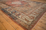 Angled view of an antique Bakshaish carpet's wide border showing mostly even wear to knot heads.