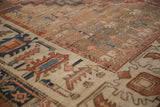 Close-up on the mostly even wear and Herati-style border of an antique Persian Bakshaish carpet.