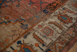 Low-pile texture and visible knot heads on the geometric border of an antique Persian Bakshaish carpet.