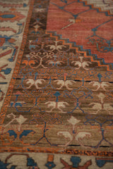 Antique Bakshaish carpet's geometric border with visible wear to the hand-knotted pile and foundation.