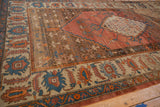 A low-angle view showing the time-softened pile and sprawling vines of an antique Bakshaish carpet.