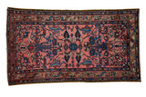 Vintage Mehriban rug with colorful floral blossoms on a dusty rose field surrounded by a dark serpent-gul border.