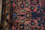 Serpent-like gul border in blues and browns on a dusty rose vintage Mehriban rug.