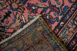 Corner detail of a vintage Mehriban rug showing the hand-knotted back and side cord.