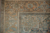 Vintage distressed Bijar rug corner showing Herati motifs and main border.