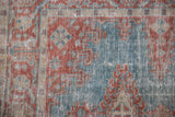 Even wear across the knot heads of the distressed Persian Veece rug in blue and red.