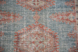 The low-pile, distressed texture of a vintage Veece rug with visible ivory foundation threads.