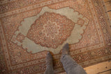 Antique Tabriz rug with a large scalloped medallion in sandalwood and pink hues on a dusty slate blue field.