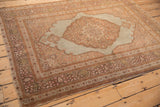 Overhead view of the antique Tabriz rug's traditional layout with its scalloped medallion and detailed borders.
