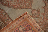Evenly worn low pile and hand-knotted back of an antique Tabriz rug seen at a folded corner.