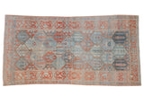 Vintage distressed Bakhtiari rug runner with a repeating panel design in cherry red and dusty denim blue.