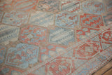 Angled detail of the worn knot heads and paneled cypress tree motifs on a Bakhtiari runner.