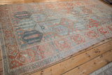 Angled view of a distressed Bakhtiari runner showing its repeating panel design and low-pile texture.