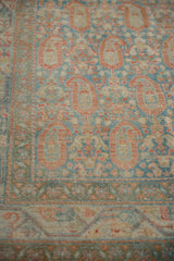 Evenly worn pile of a vintage Serbend rug showing terracotta botehs on a pale sapphire blue ground.