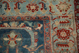 Distressed powder blue field with cherry red floral palmettes and geometric Herati style border.