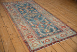 Distressed vintage Persian Mehriban runner corner: sapphire floral palmettes and cherry Herati border.