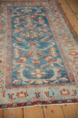 Distressed sapphire blue field with floral palmettes meeting the powder blue Herati border.