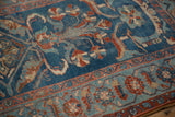 Distressed pile texture of a Persian Mehriban rug, with sapphire blue and faded red floral patterns.