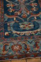 Distressed sapphire blue field, floral palmettes, and geometric Herati border on Mehriban rug.