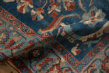 Textured blue and red floral patterns on a vintage distressed Mehriban rug detail.