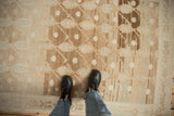 Vintage Distressed Hamadan rug showing abrashed brown-beige ground and dusty blue boteh pattern.