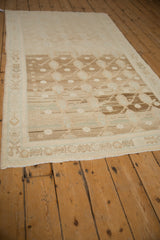 Distressed Hamadan rug's abrashed boteh field and border, featuring beige, coffee, and dusty blue tones.