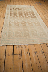 Vintage distressed Hamadan rug end with light ivory fringe and subtle blue-lined border.