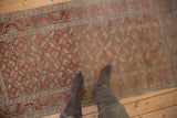 Distressed vintage Belouch runner with geometric guls, pale ruby red, and powder blue.