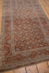 Soft ruby red and powder blue geometric guls with triangle border on distressed Belouch runner.