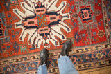 Sharp contrasting colors of the geometric starburst medallion on an antique Karaja rug.
