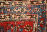 Sharp contrasting colors in the geometric borders and short pile of an antique Karaja rug corner.