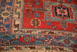 Geometric pinwheel motifs and hand-knotted texture on the border of an antique Karaja rug.
