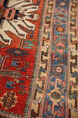 Detail showing the short pile and geometric motifs of an antique Karaja rug's red field and blue border.