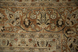 Elaborate blossoms and palmettes on a distressed Meshed carpet, displaying knot wear in terracotta and beige.
