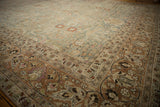 Distressed vintage Meshed carpet corner with rich terracotta border and intricate floral motifs.