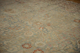Textured pile of vintage distressed Meshed carpet with intricate dusty blue and terracotta floral patterns.