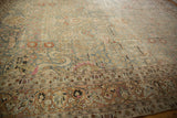 Detailed border of the distressed Meshed carpet in terracotta with pastel floral motifs.