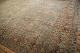 Distressed powder blue field meeting the intricate copper and pink floral border of the vintage Meshed carpet.