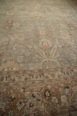 Textured distressed border of vintage Meshed carpet with terracotta and pale pink floral motifs.