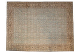 Vintage distressed Tabriz carpet with a denim blue Herati field and a brown turtle samovar border.
